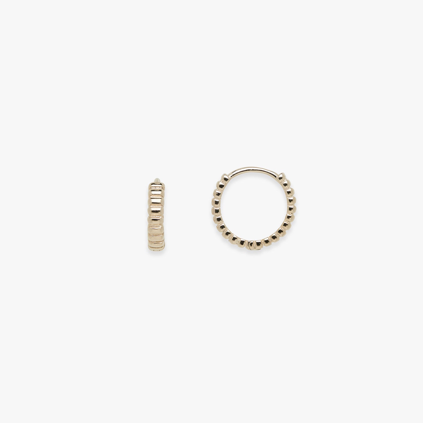 Two gold hoop earrings on a white background