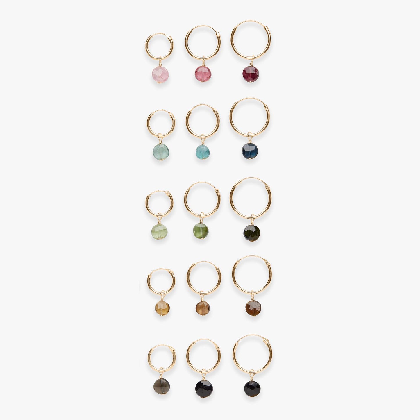 Set of gold hoop earrings with various colored gemstones on a white background