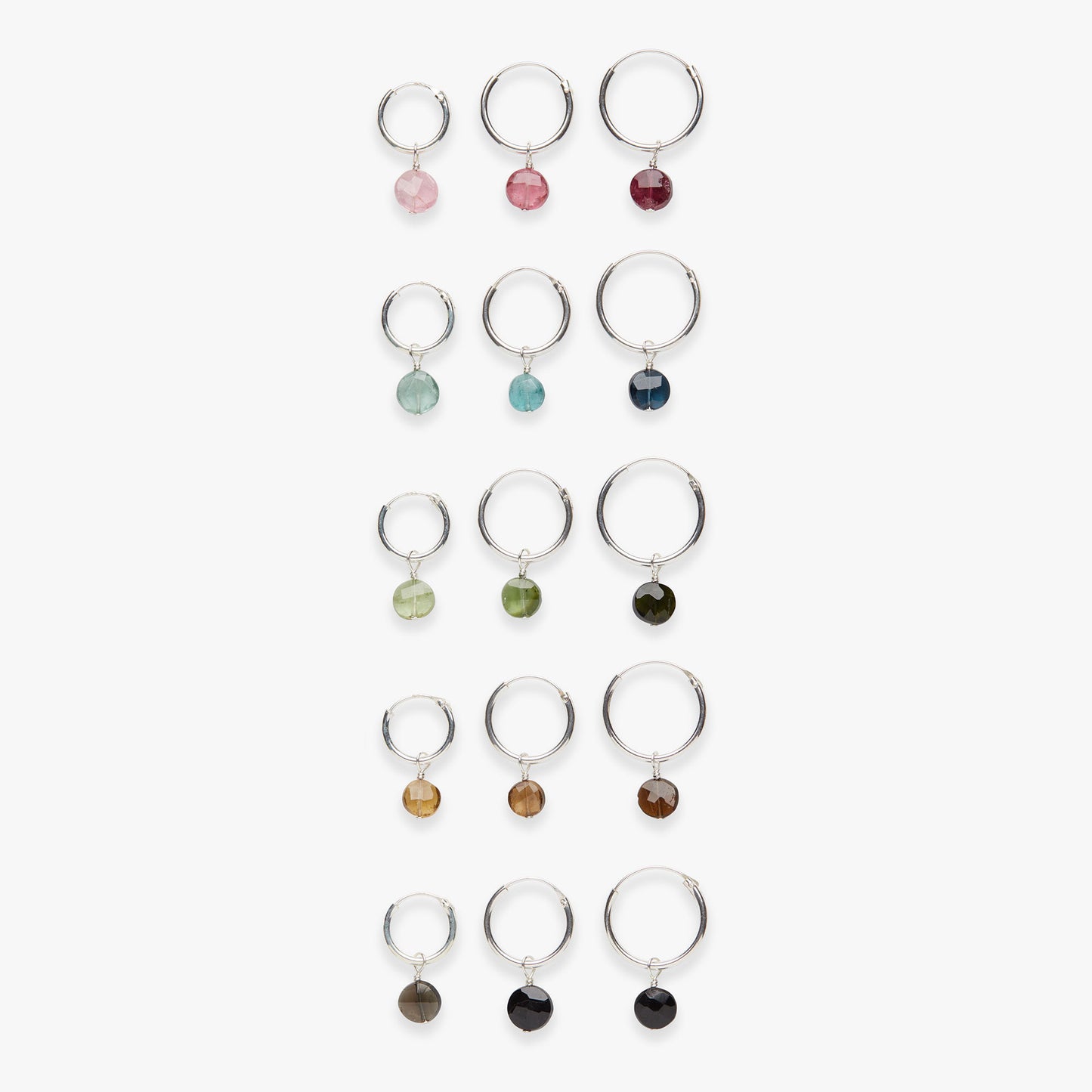 Set of silver rings with colorful gemstones on a white background
