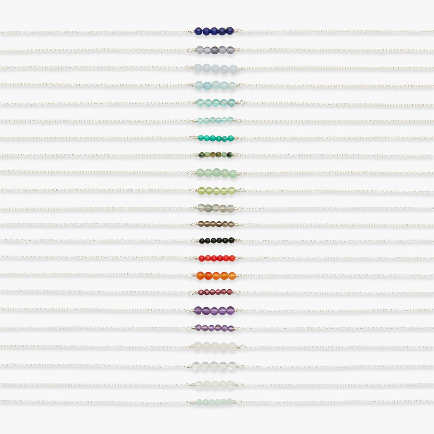 A set of white beaded bracelets arranged vertically in a column, each featuring a different colored bead strand including blue, gray, light blue, green, teal, olive, cream, black, red, orange, purple, and white.