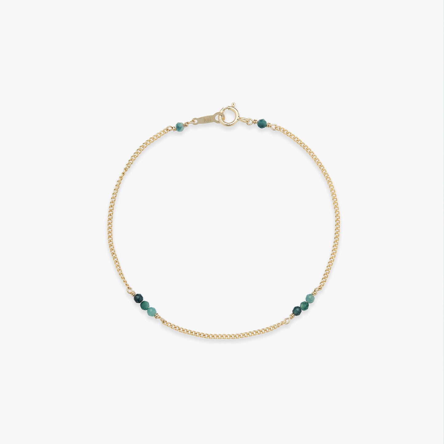 Gold bracelet with blue beads on a white background