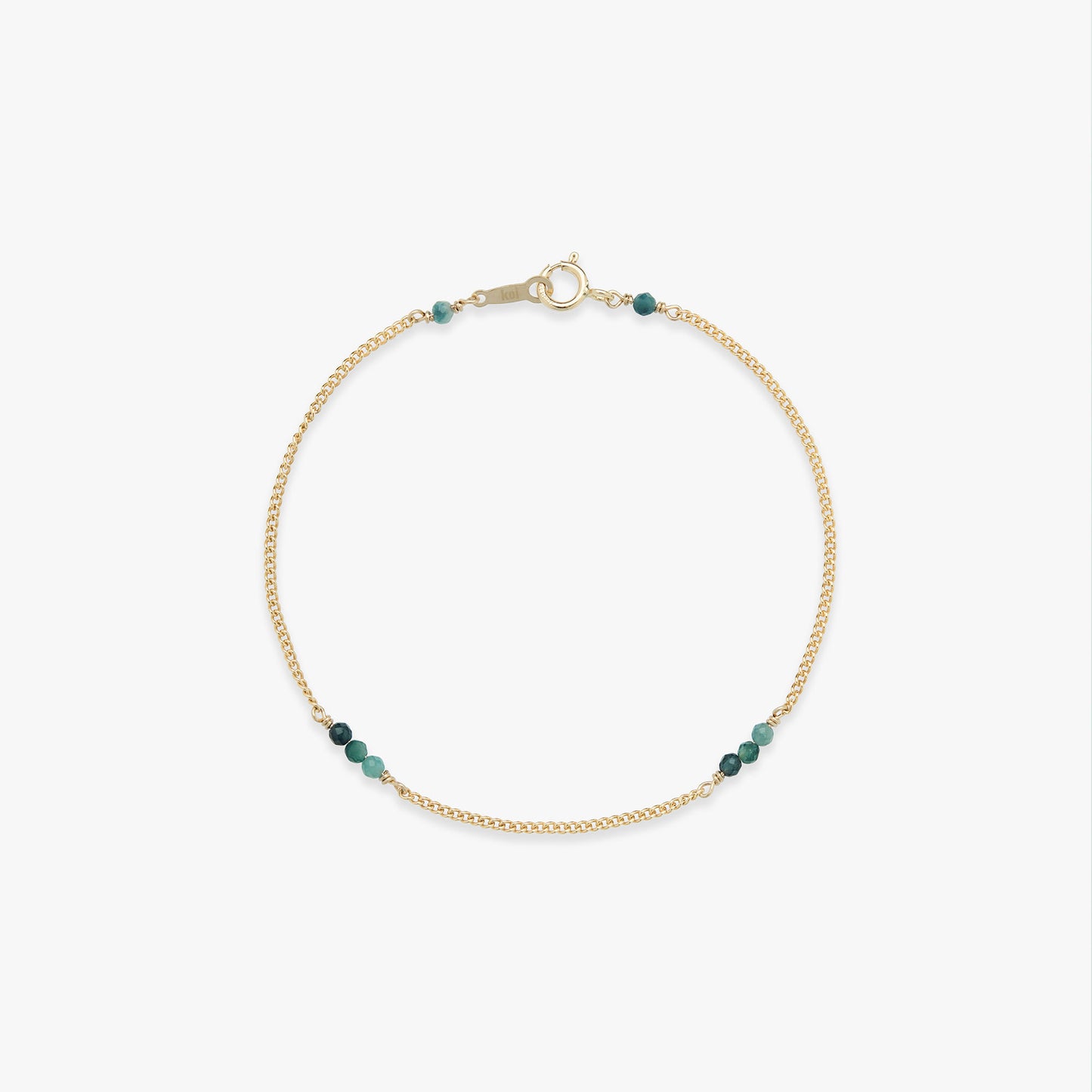 Gold bracelet with blue beads on a white background