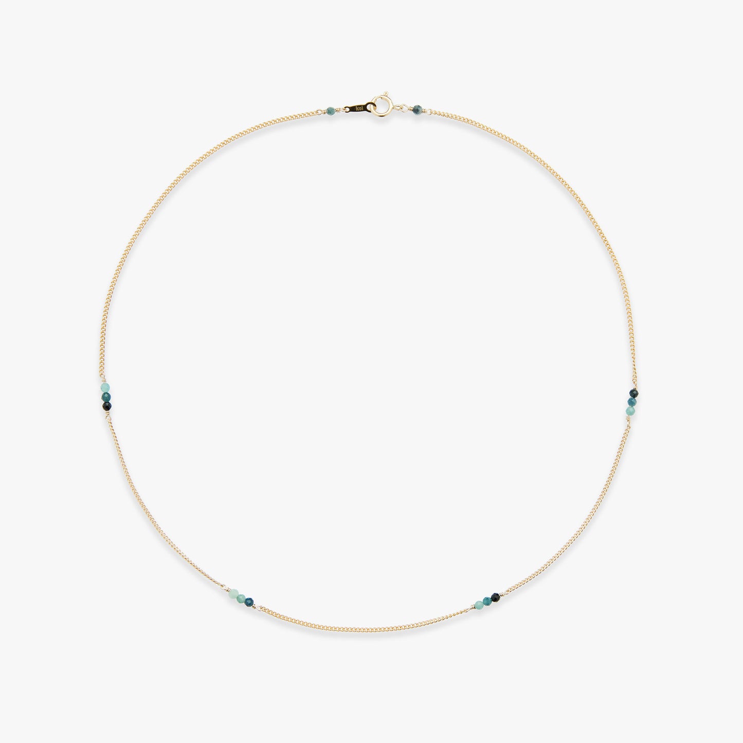 Gold necklace with blue beads on a white background