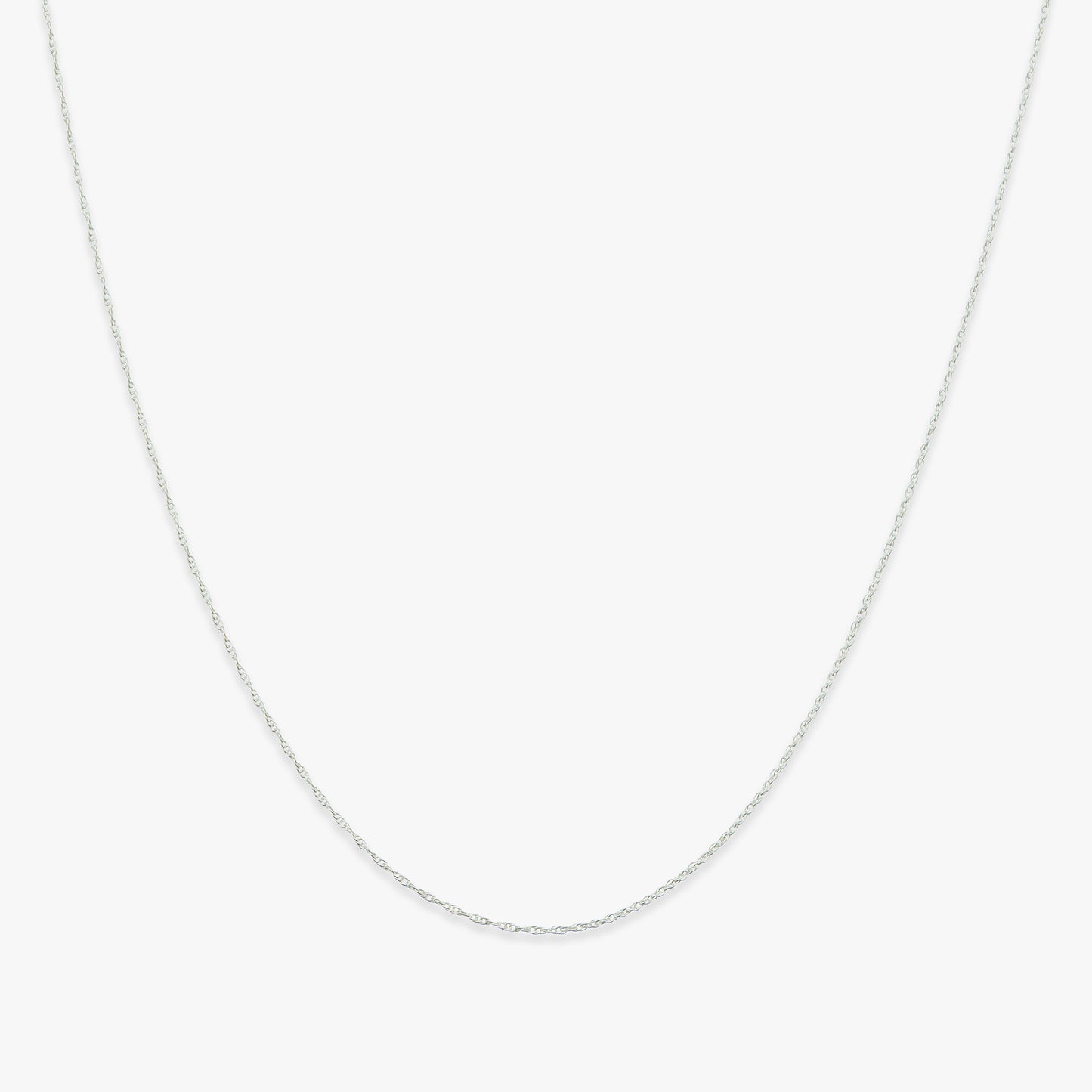Silver rope chain necklace on a white background