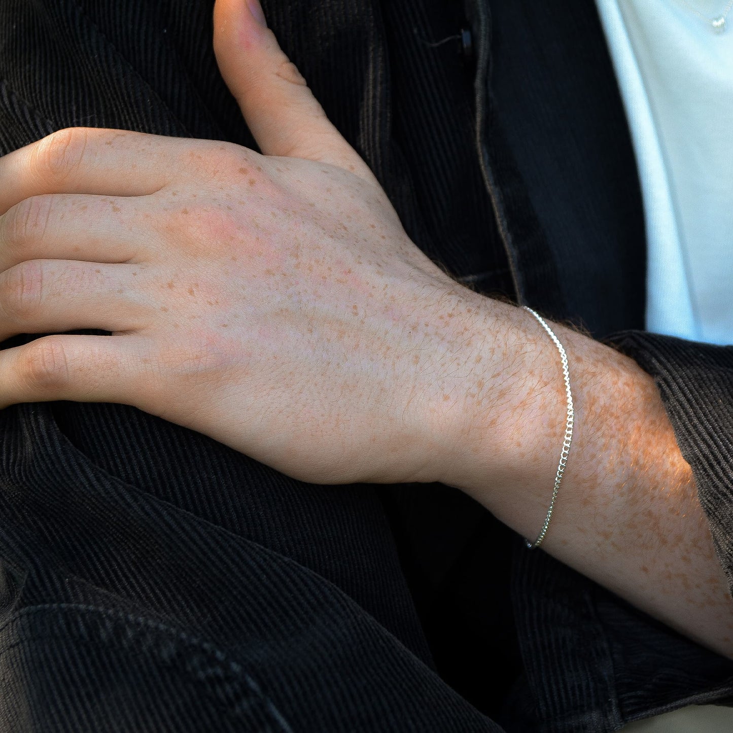 Close-up of a person's wrist with a silver bracelet